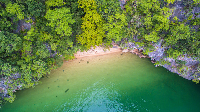 a small beach in high tide at Panak island when low tide can walk in to.the cave. Panak island is in Phang Nga Thailand