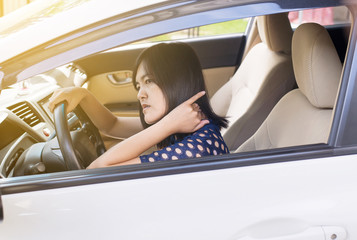 Asian woman have neck pain while driving a car,Massaging