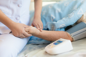 Woman doctor measured in blood of the elderly patient in the hospital room. . Medical and healthcare  in elderly people concept