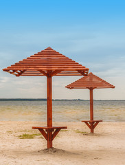 Wooden umbrellas on the beach on Lake Svitiaz