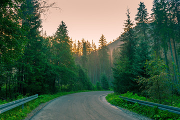 Fototapeta na wymiar asphalt road in the mountains at dawn, the path to the lake Morskie Oko, Poland