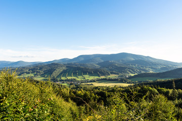 Majestic landscape of mountains and Meadow. Cycling mountain road. Misty mountain road in high mountains.. Cloudy sky with mount