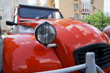Headlamp of red vintage car, business concept.