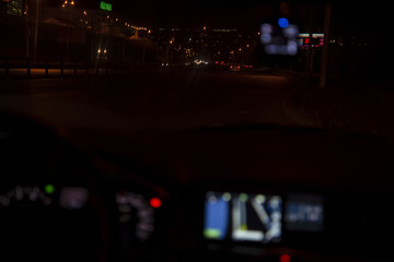 Night city lights from inside the car