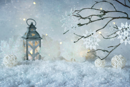 Frosty winter wonderland with snowfall and magic lights.  Christmas greetings concept