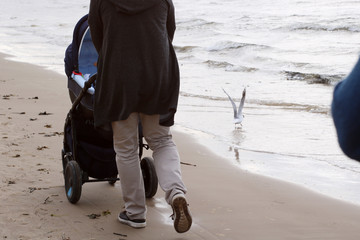 Father is walking around with son in baby buggy