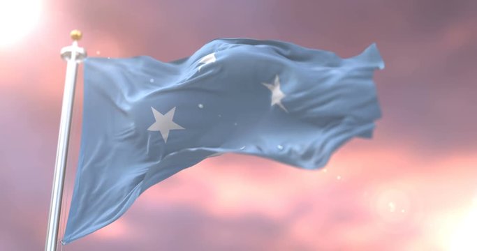 Flag of the Federated States of Micronesia waving at wind at sunset in slow, loop