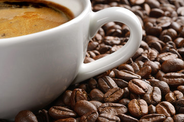Coffee cup and coffee beans background macro