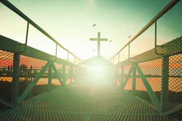Road to heaven concept：silhouette christian cross at   bridge and orange sky with lighting