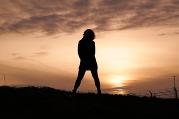 mysterious people on a hill at sunset