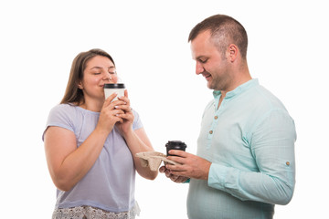 Portrait of young happy couple enjoying cup of coffee