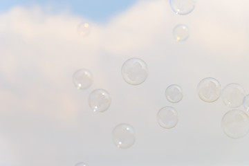 Soap bubbles in the air with cloud and blue sky on background, Outdoor activity funny and party