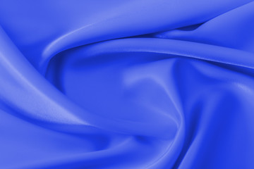 Smooth elegant blue silk or satin luxury cloth texture can use as abstract holidays background. Luxurious Christmas background or New Year background design.