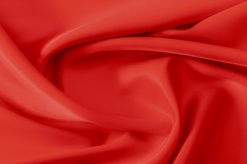 Smooth elegant shiny red silk or satin luxury cloth texture can use as abstract holidays background. Luxurious Christmas background or New Year background design.