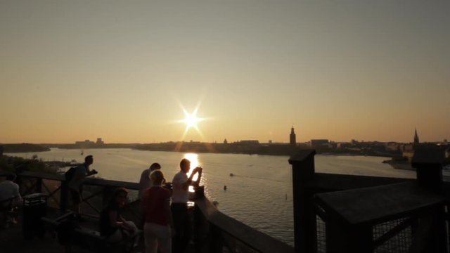People Enjoy Themselves In A Social Setting Near Stockholm's Beautiful Waterways