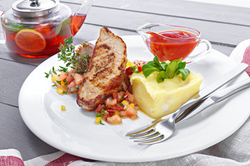 beef steak with mashed potatoes close up on wooden background
