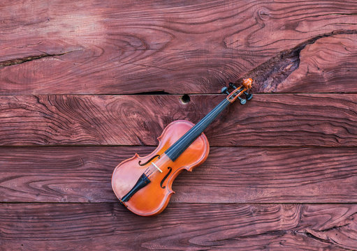 violin on a red wooden background