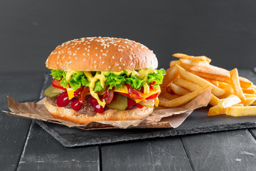 Hamburger with fries on a slate plate