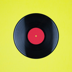Closeup of Vinyl Long Play Record with Label with Copy Space on yellow background