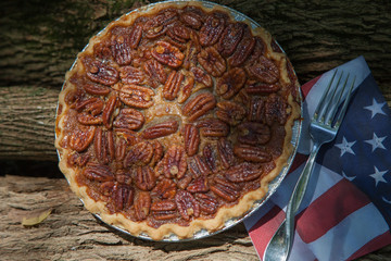 Close up shot of a pecan pie cooling. American classic homemade pecan pie. Amish pies. Napkin a flag of USA. American pies.