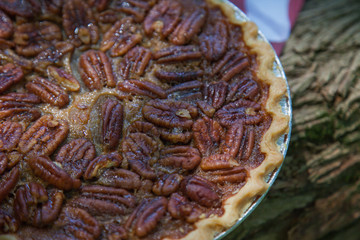 Close up shot of a pecan pie cooling. American classic homemade pecan pie. Amish pies. Napkin a flag of USA. American pies.