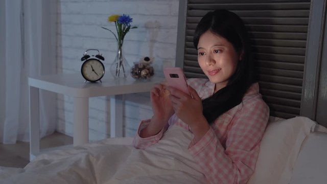 Lady using the phone in the dark.