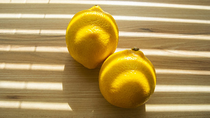 Yellow ripe lemons on wooden background