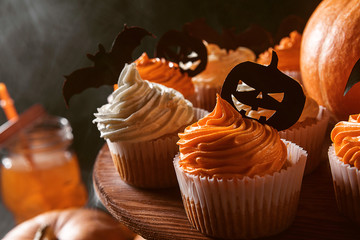 cupcake and pumpkin on a dark background. sweets for the celebration of Halloween.