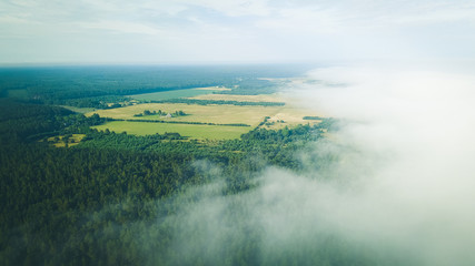 Misty sunrise over countryside path Aerial view Latvia