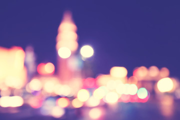 Blurred city lights at night, color toning applied.