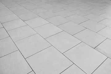patterned paving tiles, ceramic brick floor background - monochrome