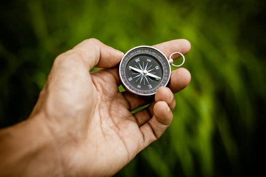 compass in a hand at the jungle.