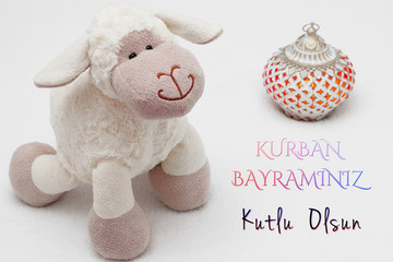 Greeting card on white background. Eid Al Adha sacrifice festival, Islamic Arabic candles and sheep. Kurban bayramınız kutlu olsun means happy festival of sacrifices