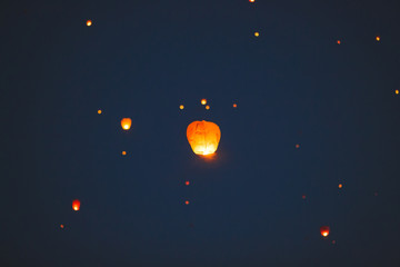 Flying lantern in the dark sky