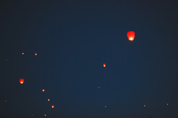 Flying lantern in the dark sky