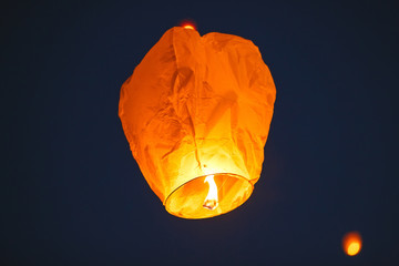 Flying lantern in the dark sky © davit85