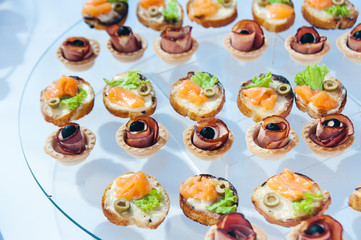 canape set with salmon fish and meat at luxury reception. catering food service