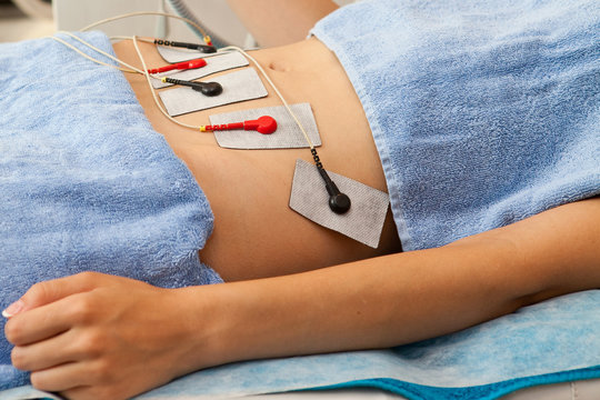 Body cosmetic treatment with Tissue electron stimulation on young woman in SPA salon