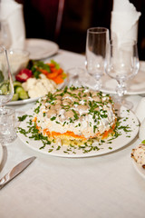 Served for a banquet table with glasses and white napkins and salads, vegetables