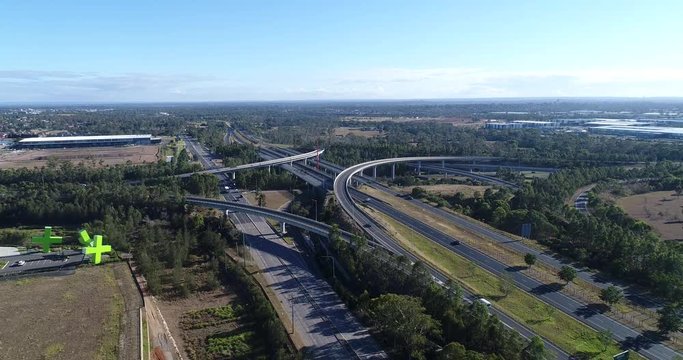 Along Sydney Western suburbs Motorway M7 at Light Horse intersection with Motorway M4 on a sunny day lowering and descending down to ground.
