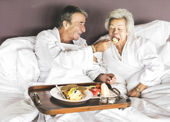 Couple having breakfast in bed