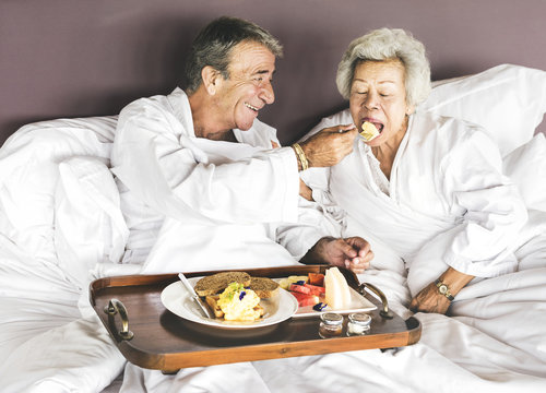 Couple having breakfast in bed