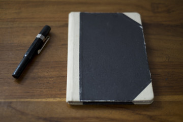 old style notebook with a fountain pen