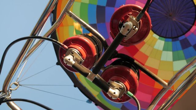 Hot air burning by gas fire to air balloon or aerostat during flight, close up