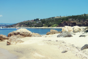 Fototapeta na wymiar Beautiful sandy beach with big rocks near Ouranoupolis, Greece.