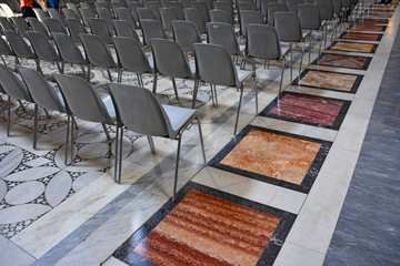 Seats sorted by religious services in a typical Italian church.