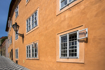 Fototapeta na wymiar Old orange house on the street of Prague