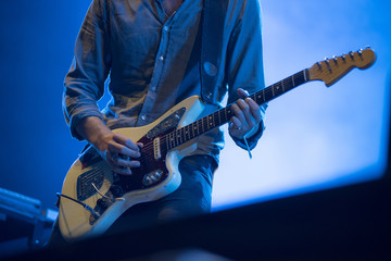 Musician's hands playing electric guitar