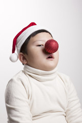 an asian little boy with red nose be happy on the white background.
