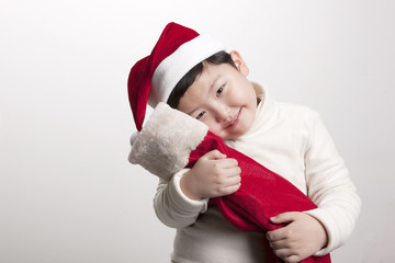 a little asian boy with christmas gift be happy on the white background.